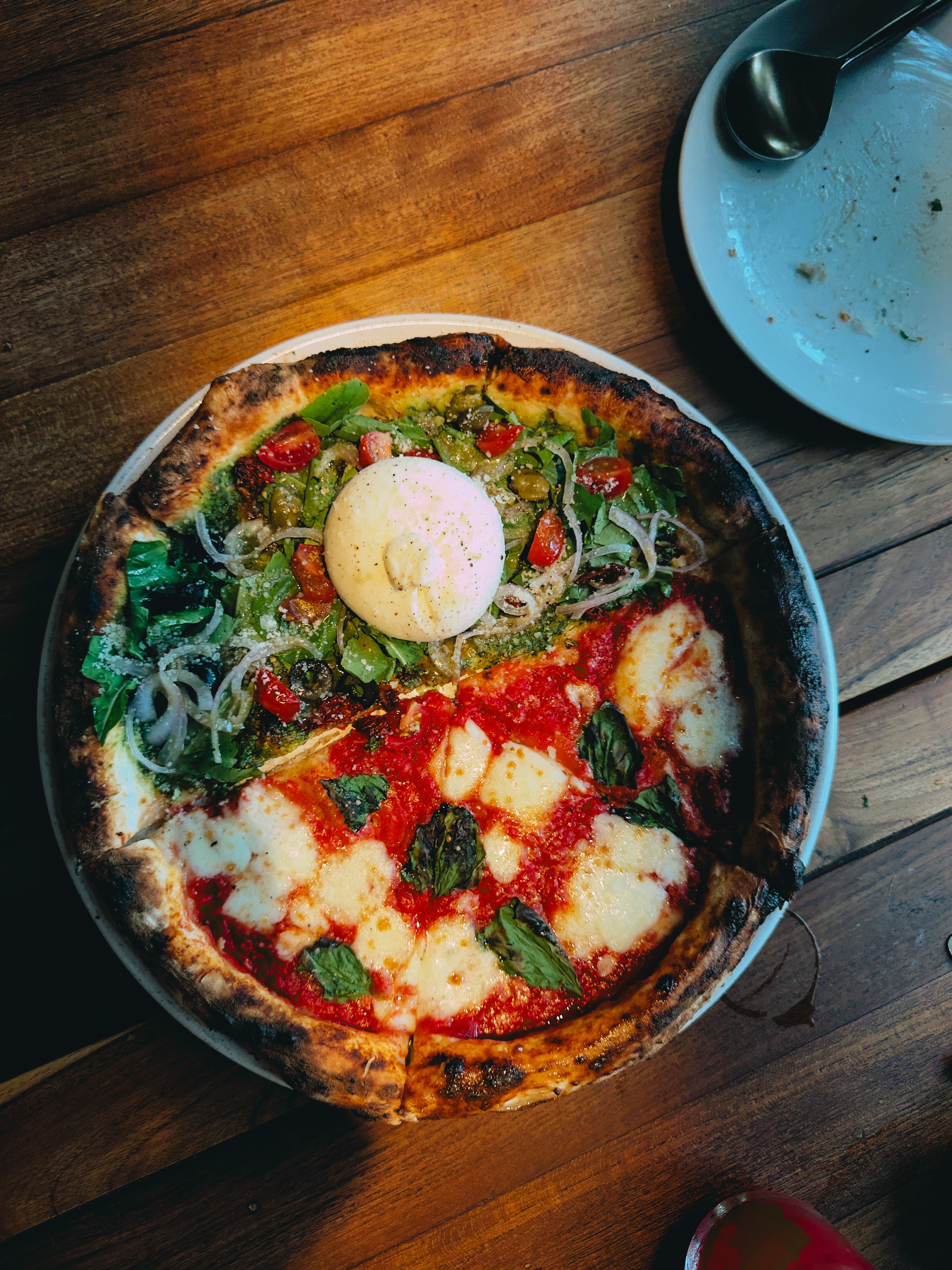 Neapolitan pizza topped with burrata, viewed from above